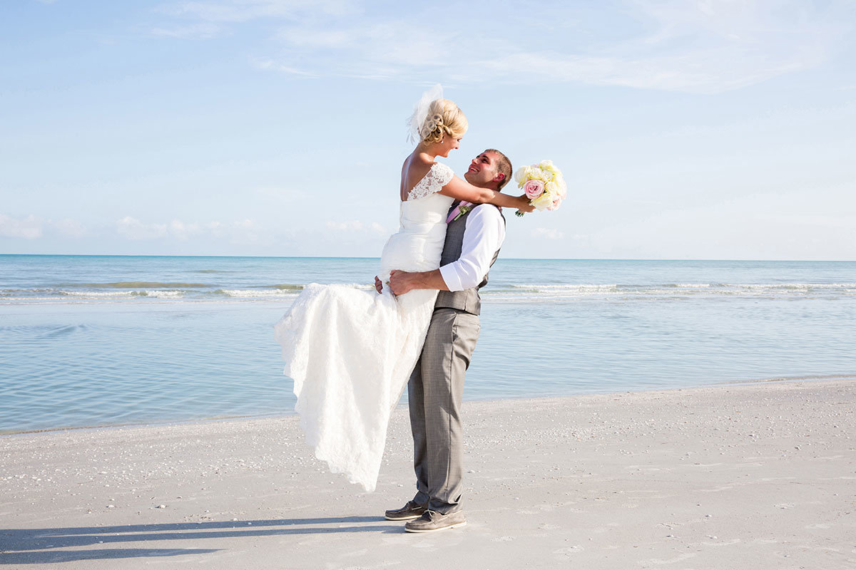 groom lifting bride casa ybel sanibel wedding