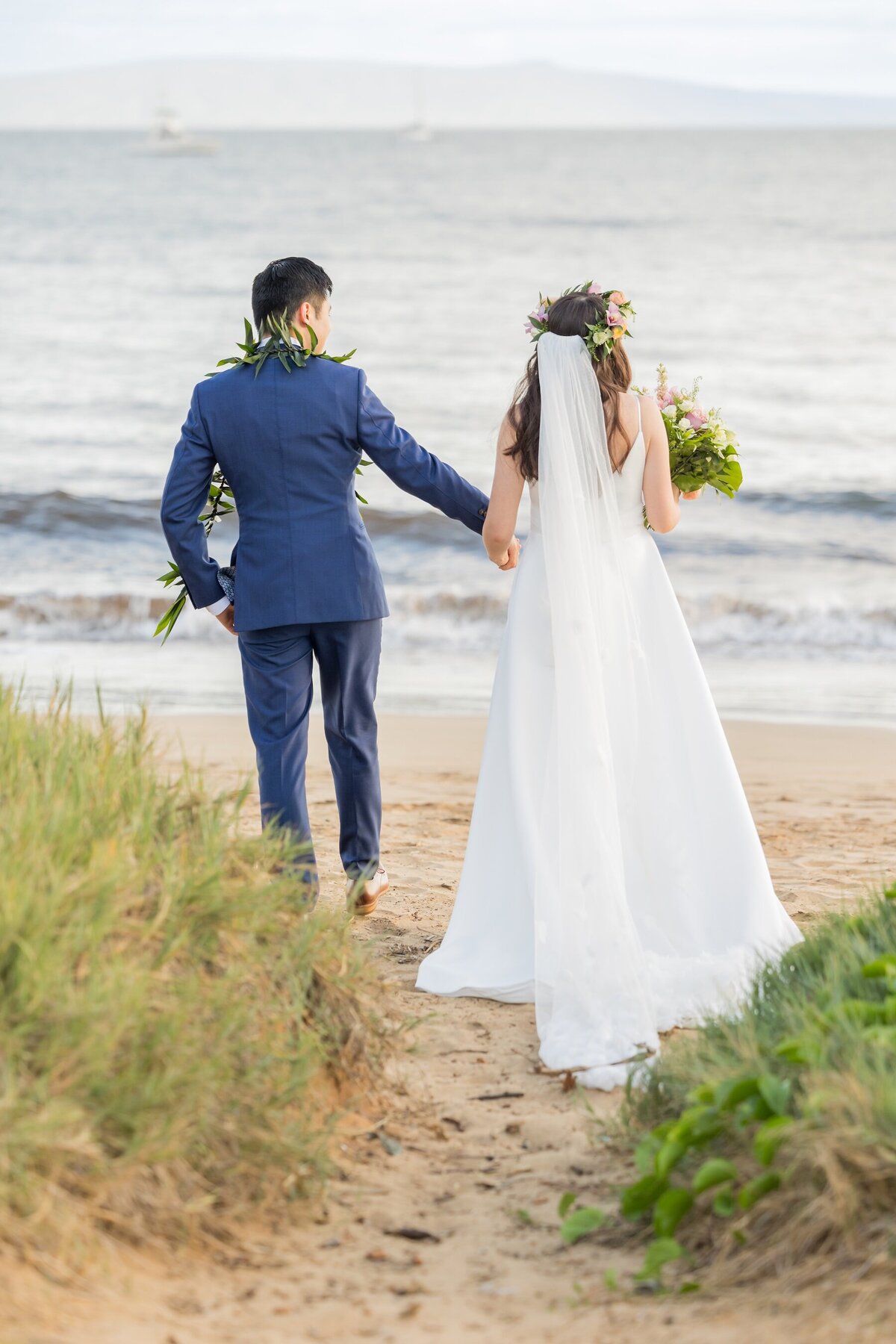 bride and groom walking on the beach in Maui Hawaii