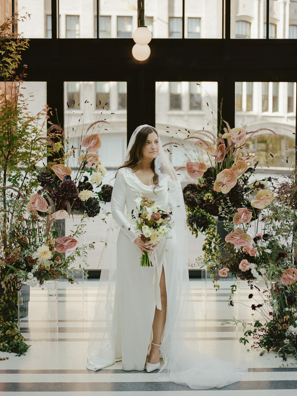 bride in long cathedral lace mantilla veil, fall wedding flowers, ceremony install in Shinola Hotel Birdy room