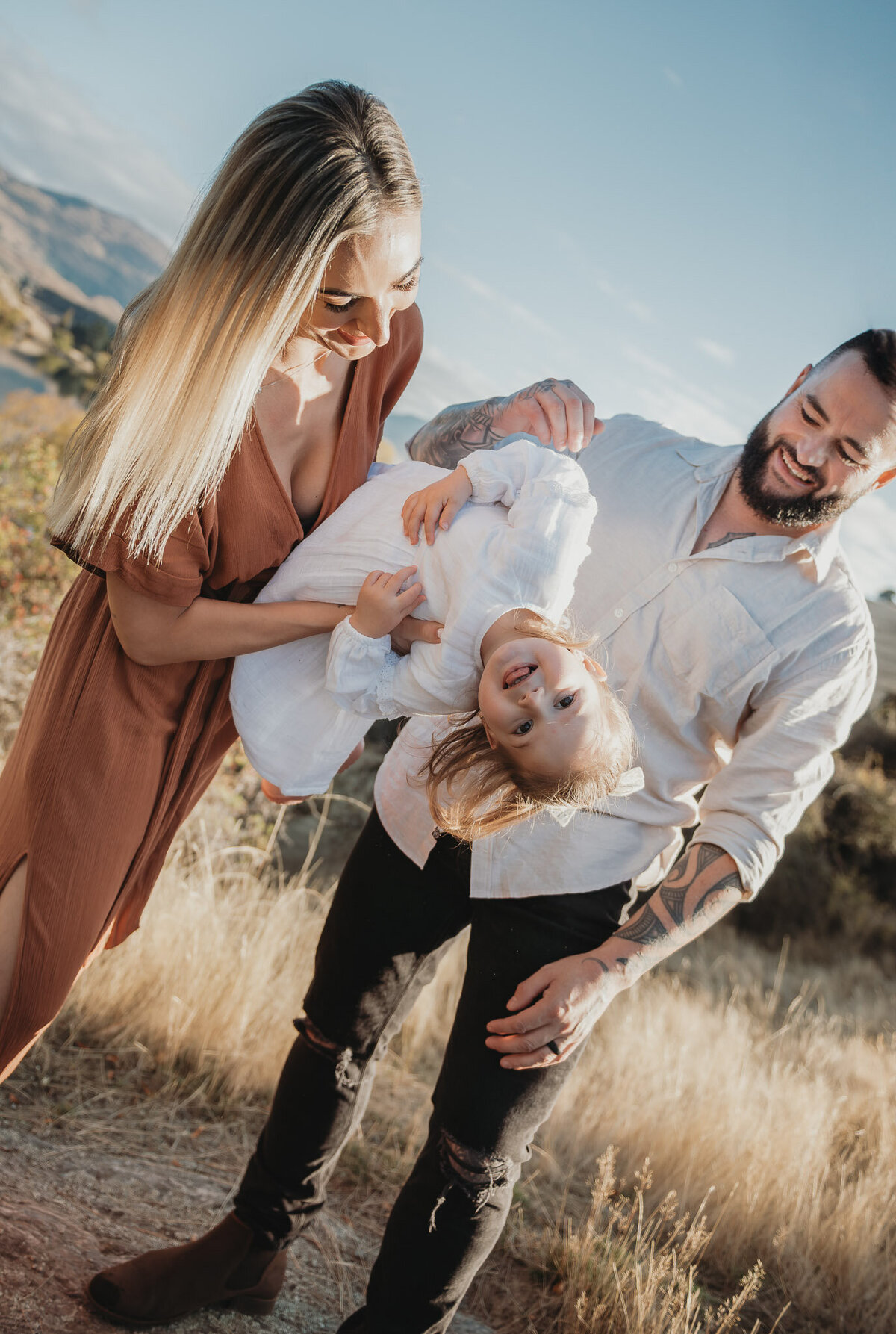 parents playing with their daughter during a Queenstown family photography session captured by Bie