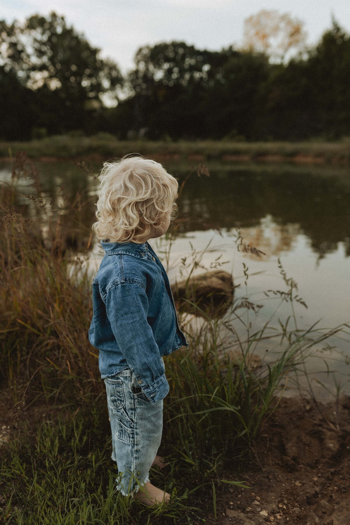 Candid moment of child at a pond during golden hour in Missouri