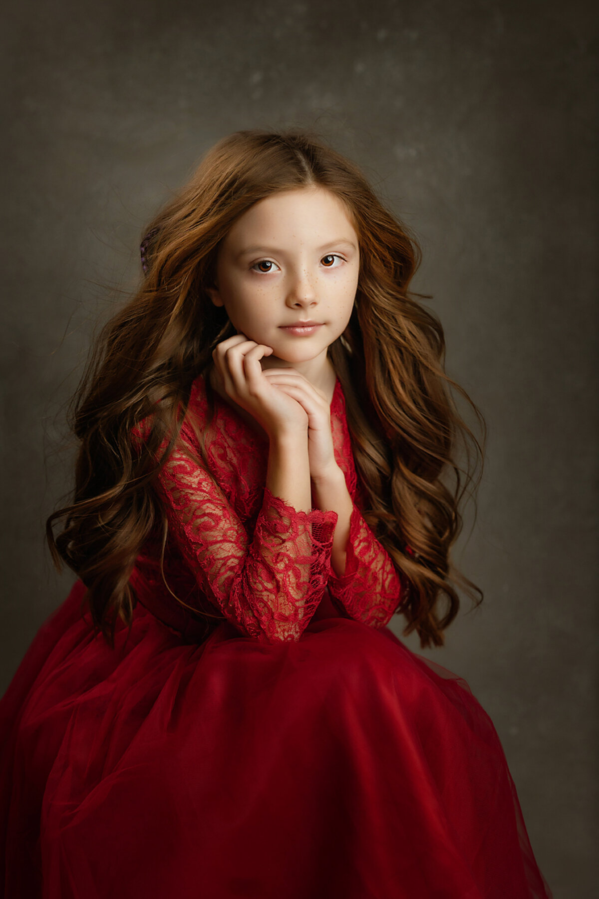 Child smiling calmly into camera for childrens portrait