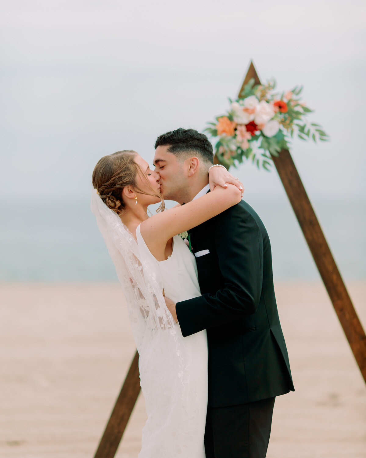 A newlywed couple during their first kiss 