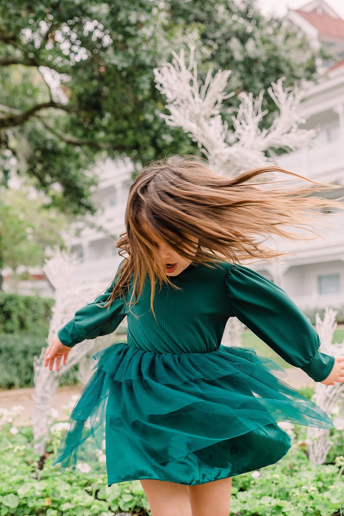 Little girl twirling with her hair and dress in the air