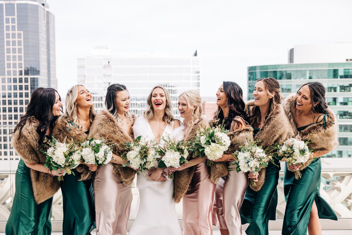 Bride and bridesmaids smiling on the Starlight Terrace at Hotel Kansas City
