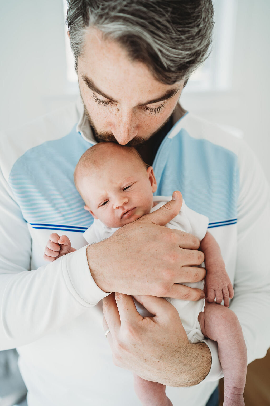 dad holding his newborn daughter