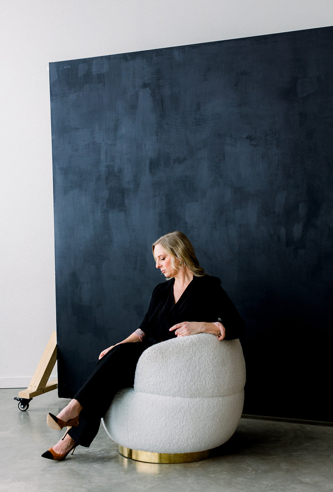 Brand photo of Calgary business woman sitting on white chair