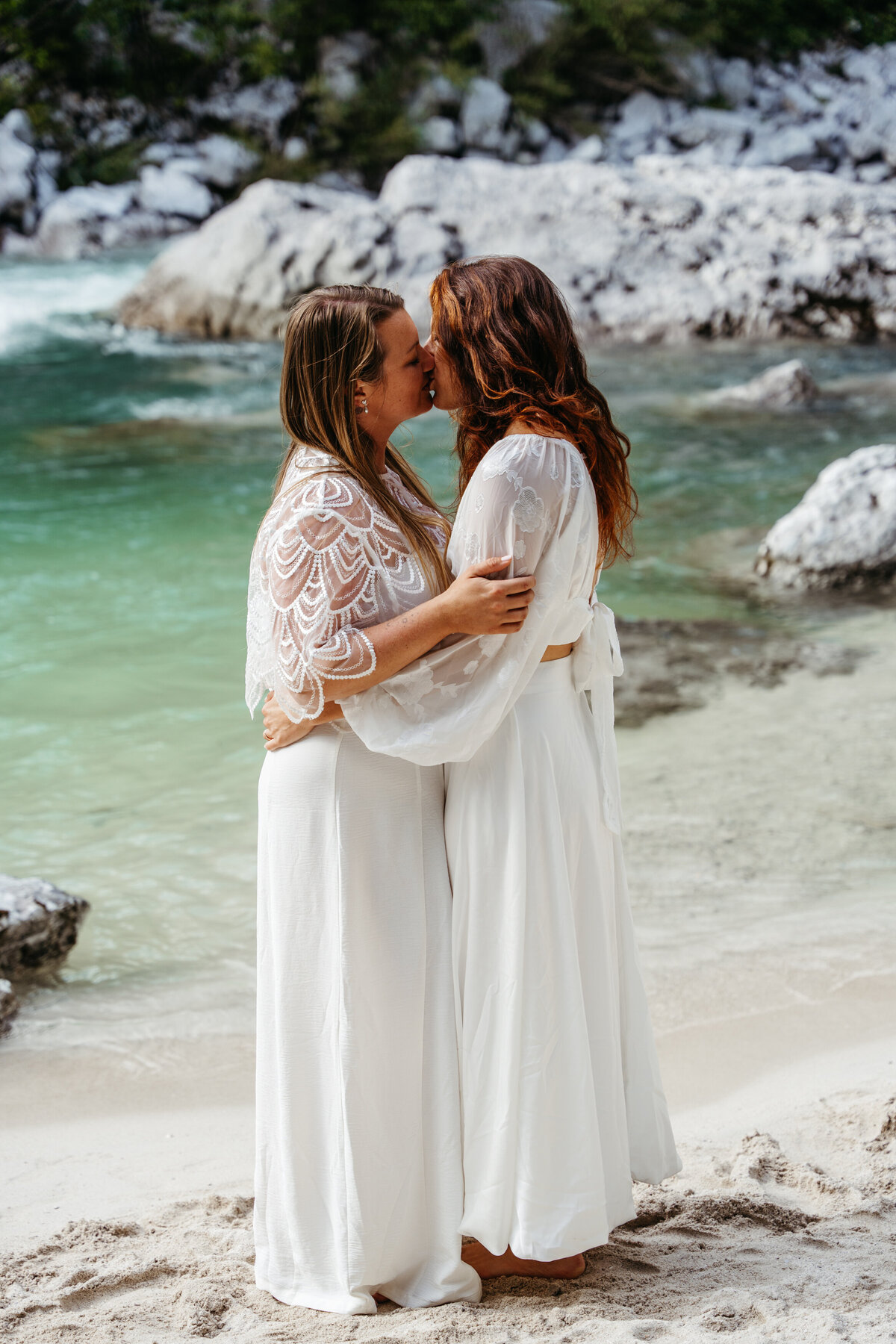 lesbian couples kissing riverside elopement Slovenia