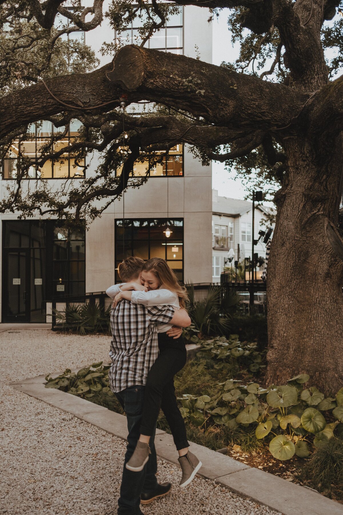 Newly engaged couple wearing casual clothing on South Congress Avenue in Austin. Engagement photo by photographer in Austin | Photos by Meggie