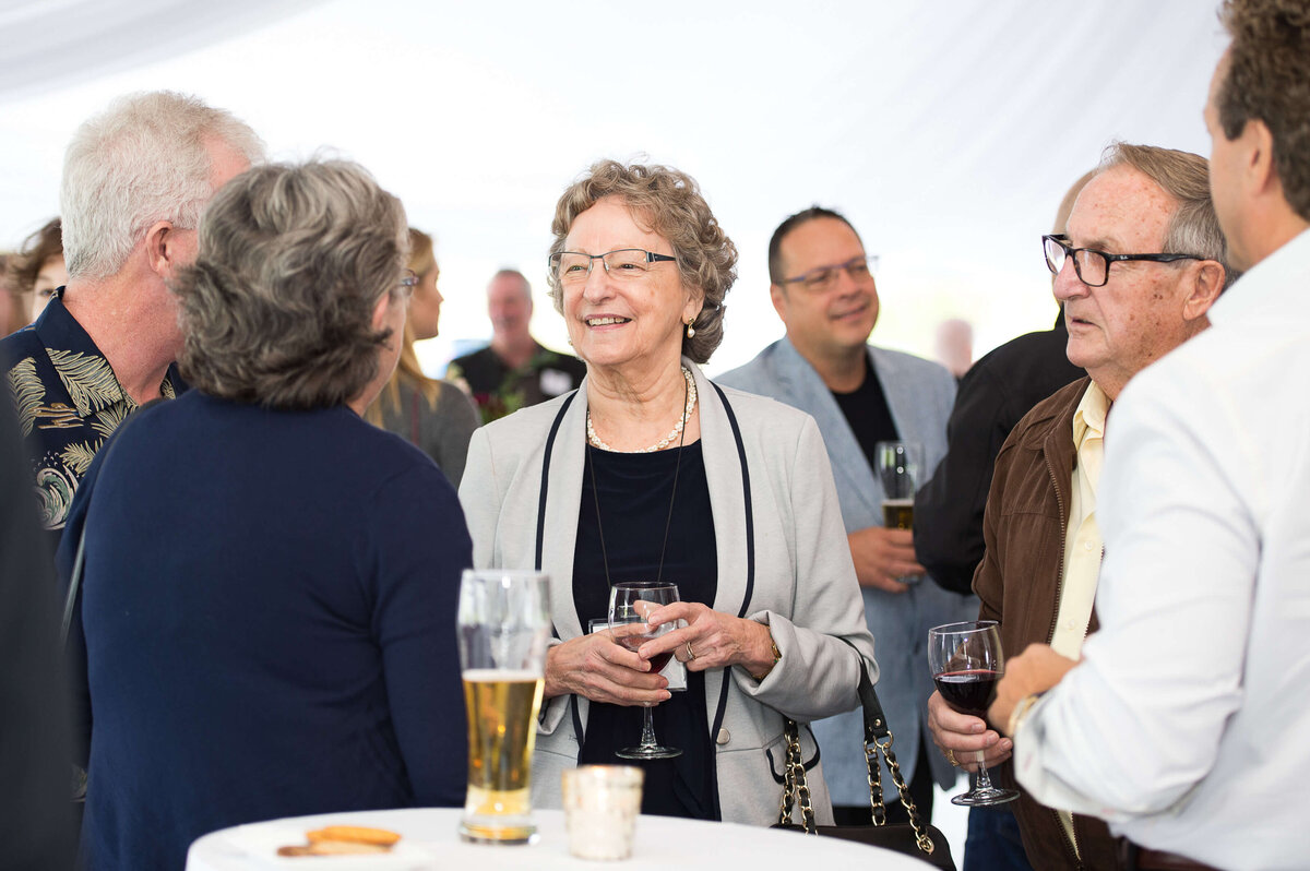 a candid photo of guests mingling at a corporate anniversary celebration.  Captured by Ottawa Event Photographer JEMMAN Photography COMMERCIAL