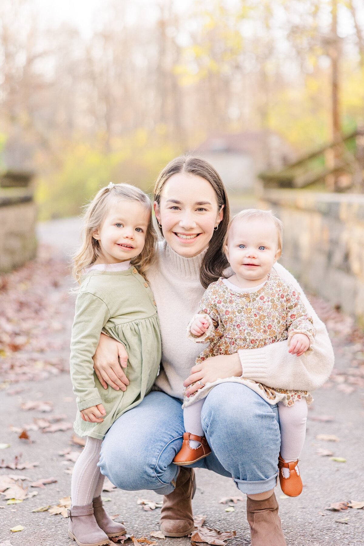 Mom smiling with her two little girls by an Ohio family photographer