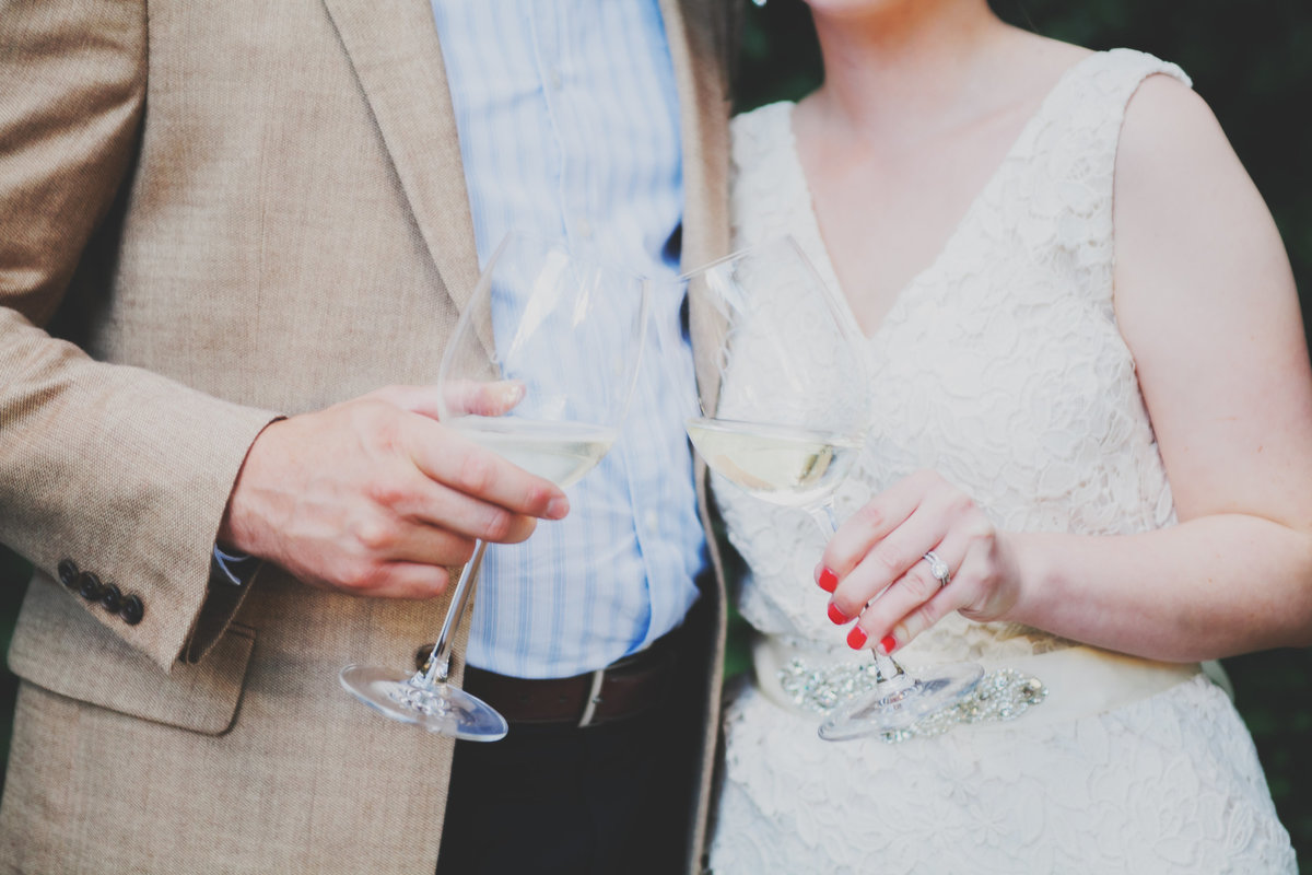 close up photo of bride and groom toasting with wedding flutes  | Susie Moreno Photography