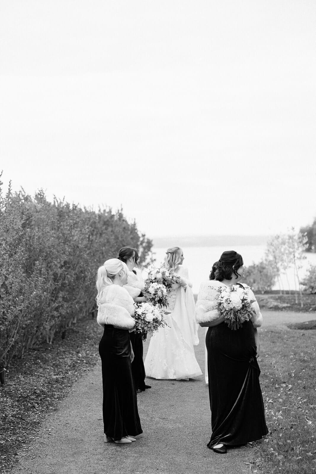 Bride looking sideways with bridesmaids at The Lake House on Canandaigua, Finger Lakes, NY