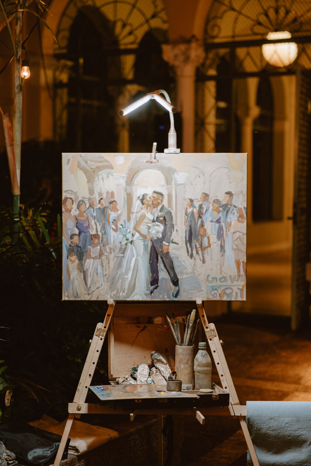 Paining of bride and groom part way finished on an easel