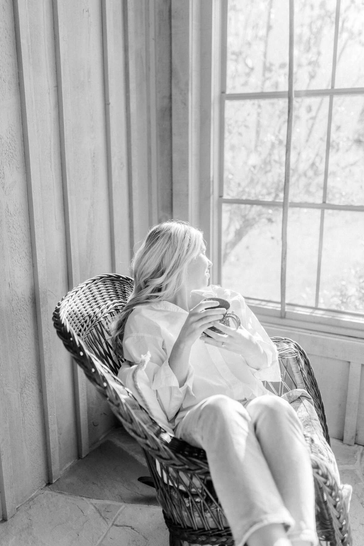 A tranquil sunroom at Elora ON, with light streaming through the large windows, inviting quiet moments of conversation.