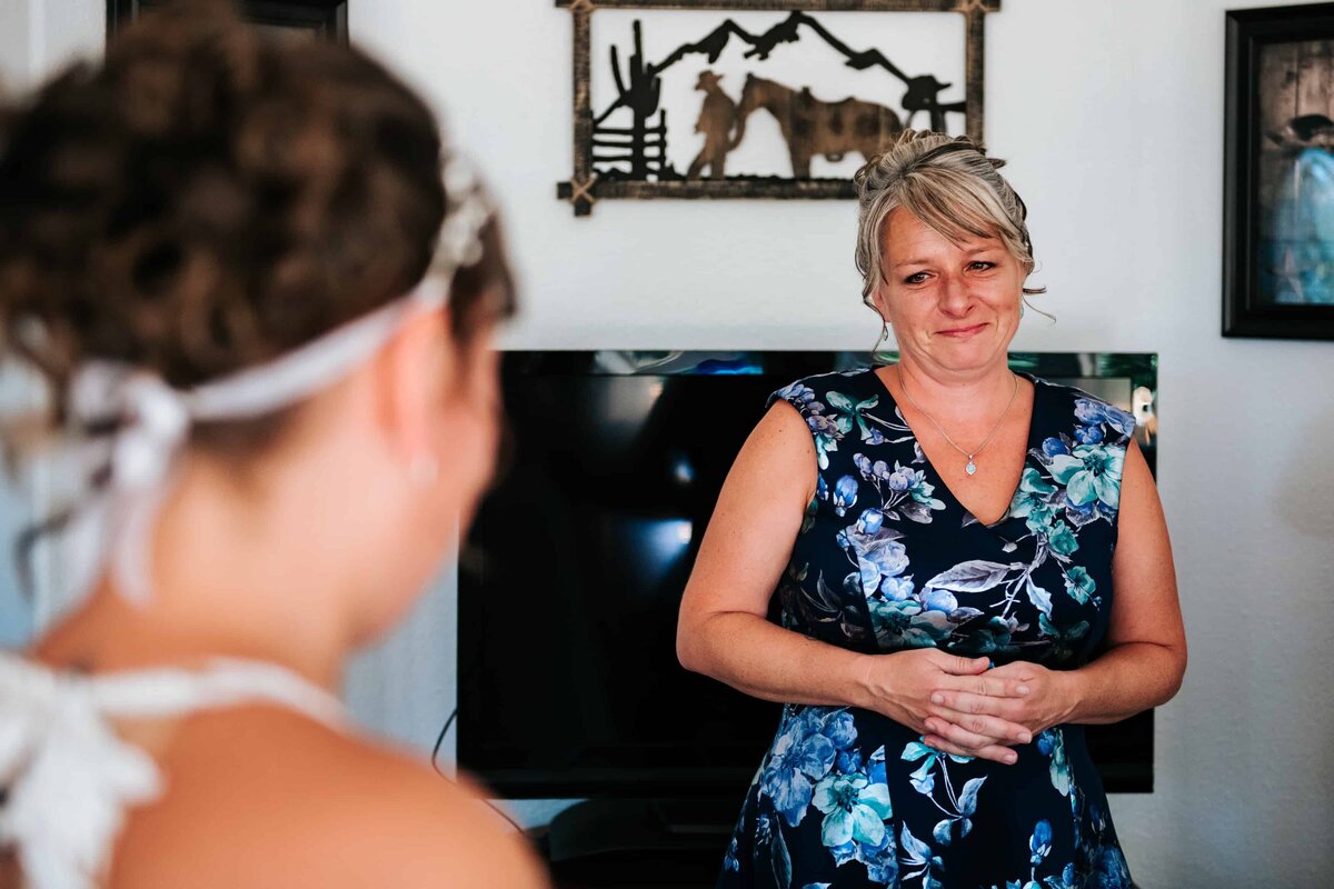 mother of the bride reacts to seeing bride in wedding dress