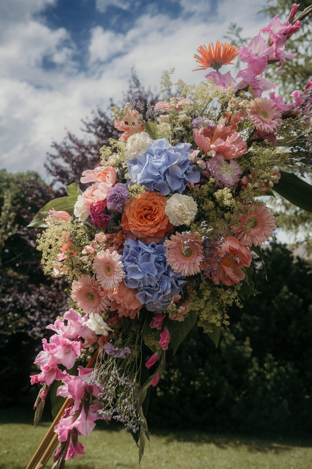 Detailshot of the colorful flower arrangement at the wedding arch.