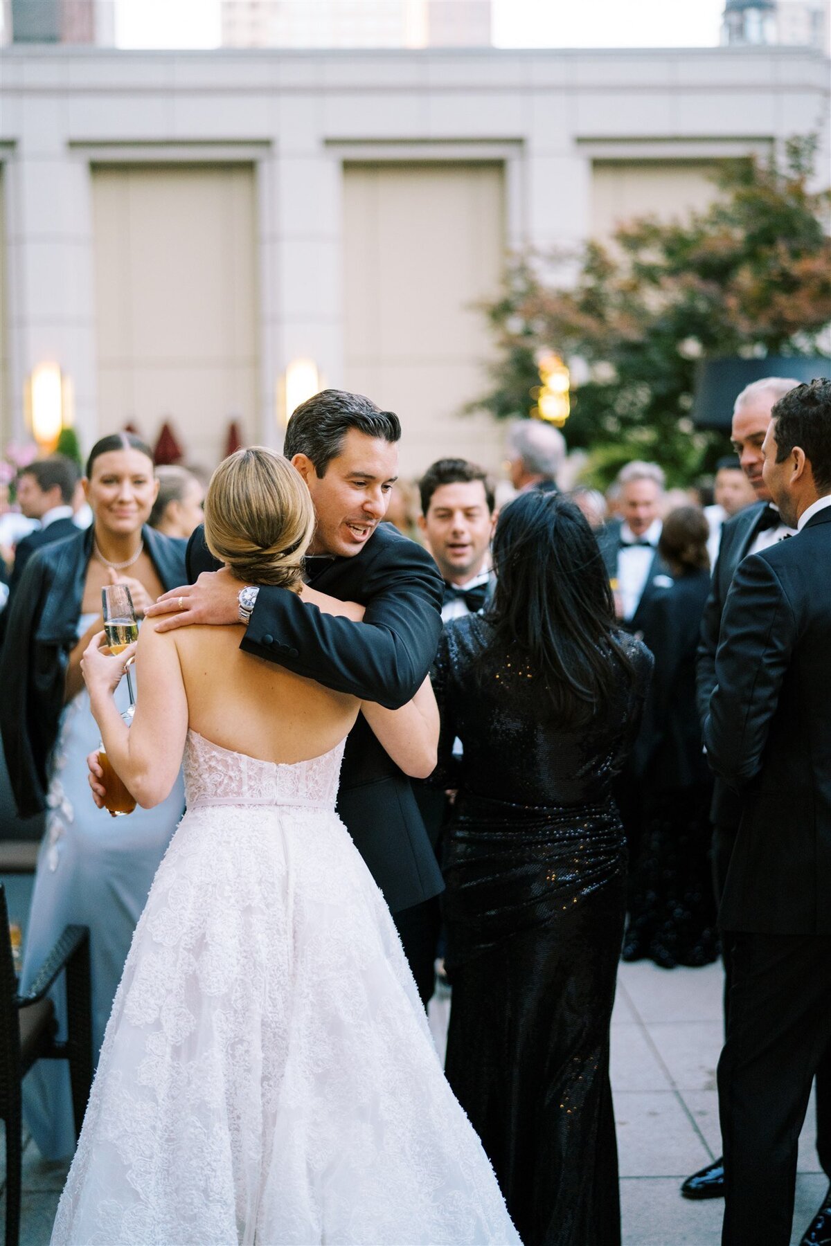 A picture of the bride hugging a guest at the reception. 