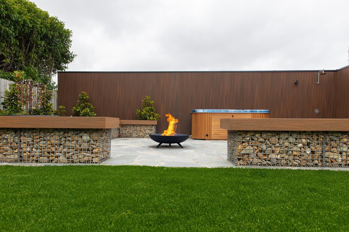 Rock work landscape design with outdoor fireplace by total landscapes & design Warrnambool