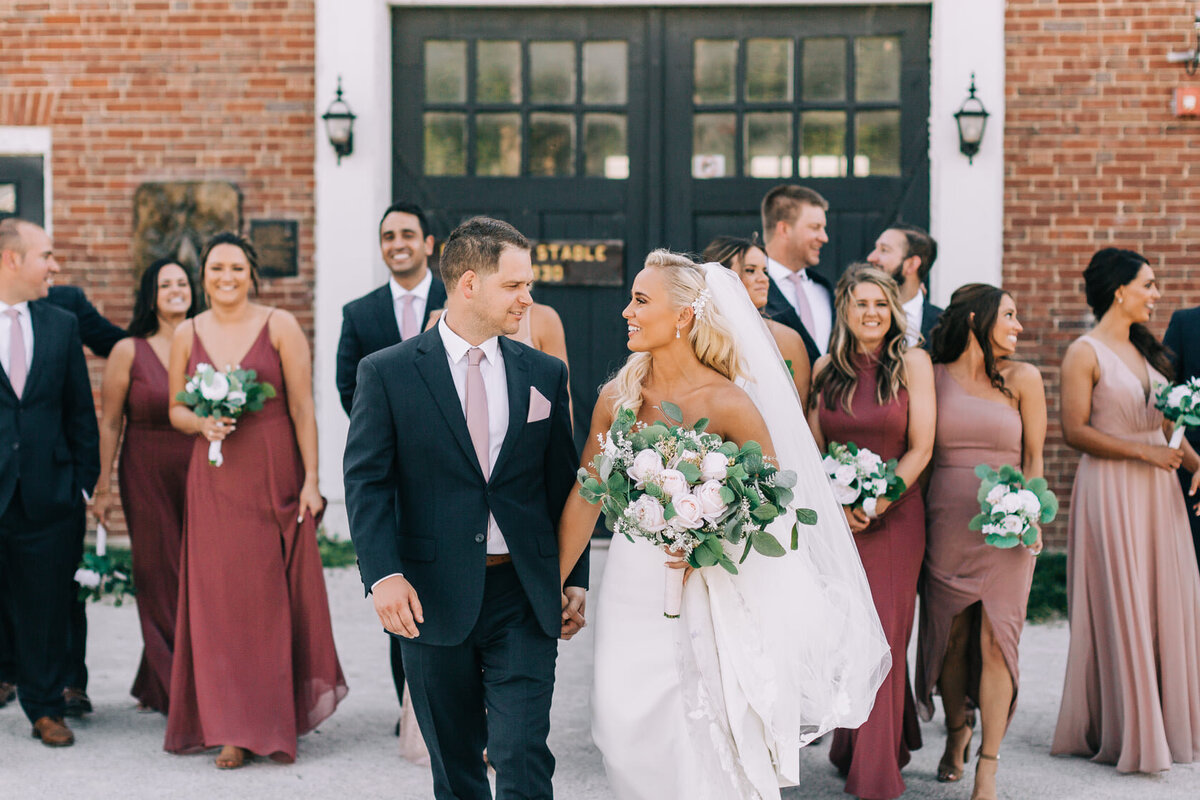 dempseandmikewalkingwithbridalpartyphoto