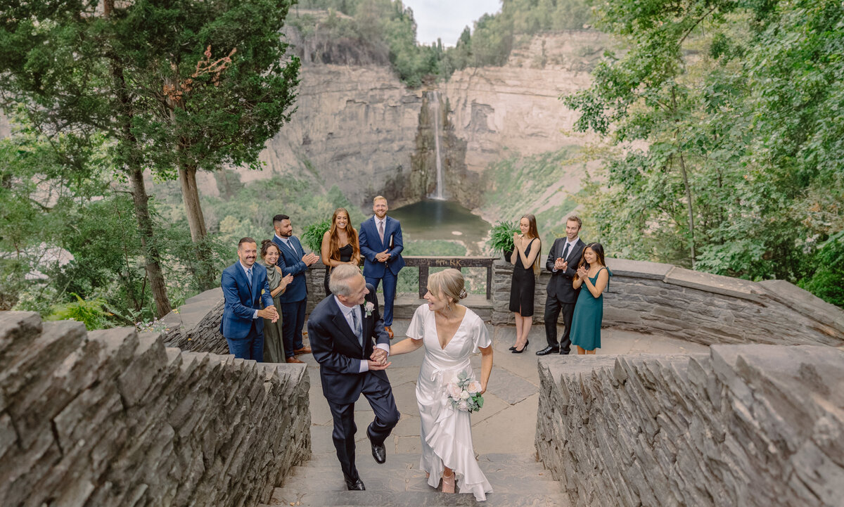 Wedding guests looking at bride as she walks down the aisle at Finger Lakes wedding NY