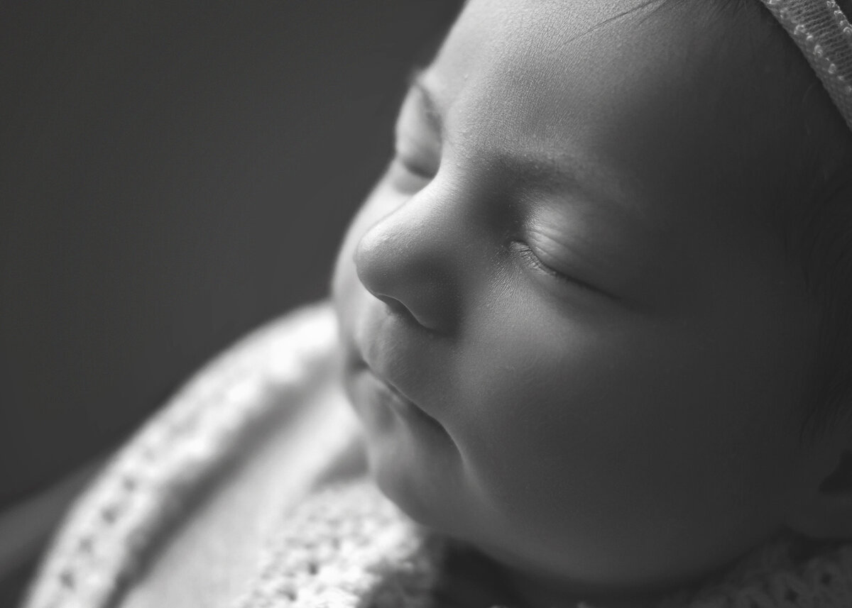 Newborn baby girl sleeping close up detail of nose and eye lashes