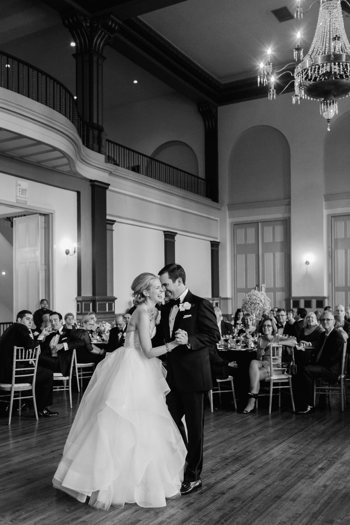 Couple shares a laugh during their first dance at a wedding reception in Chicago