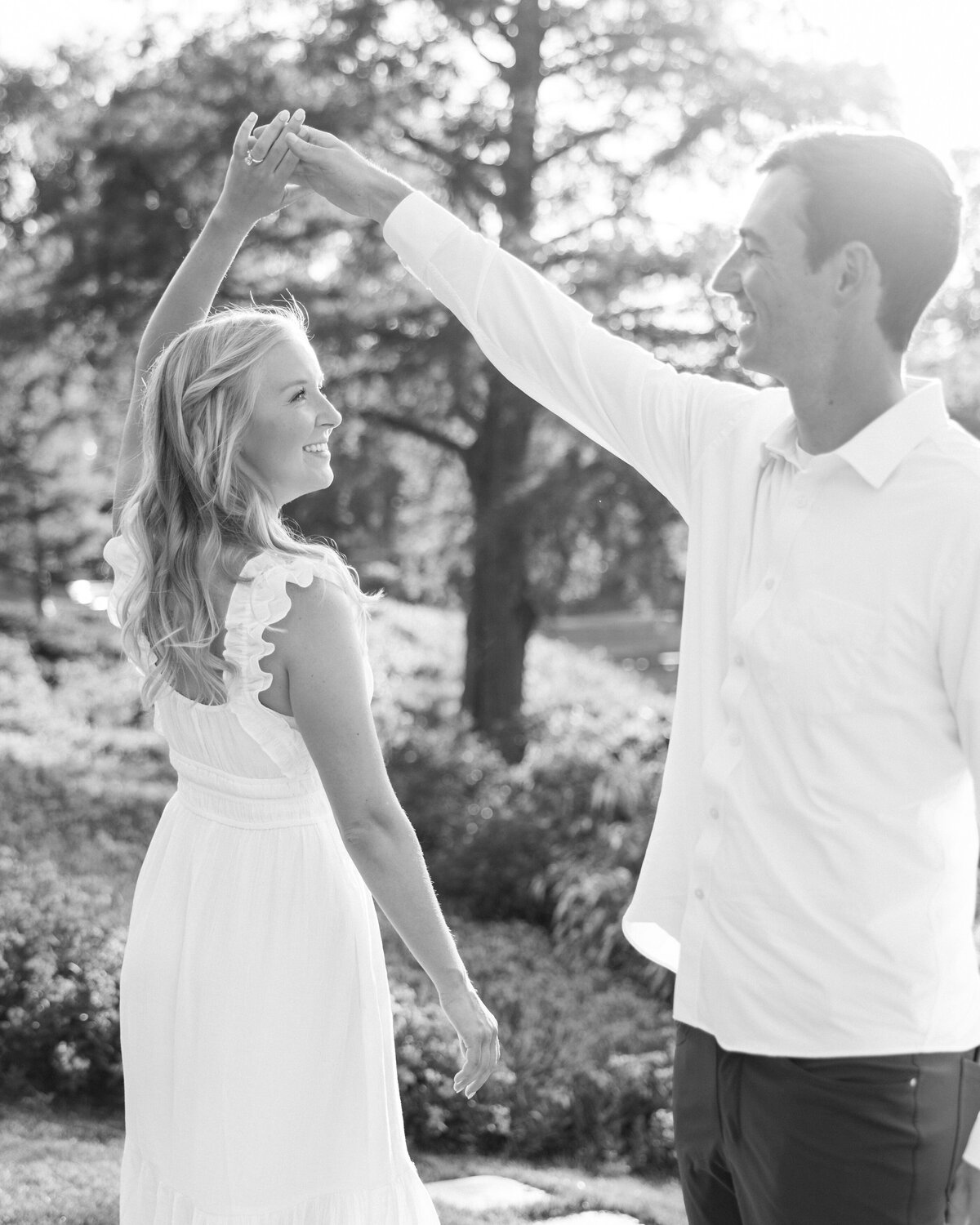 Romantic twirl in garden during Columbus engagement session with Philadelphia photographer.