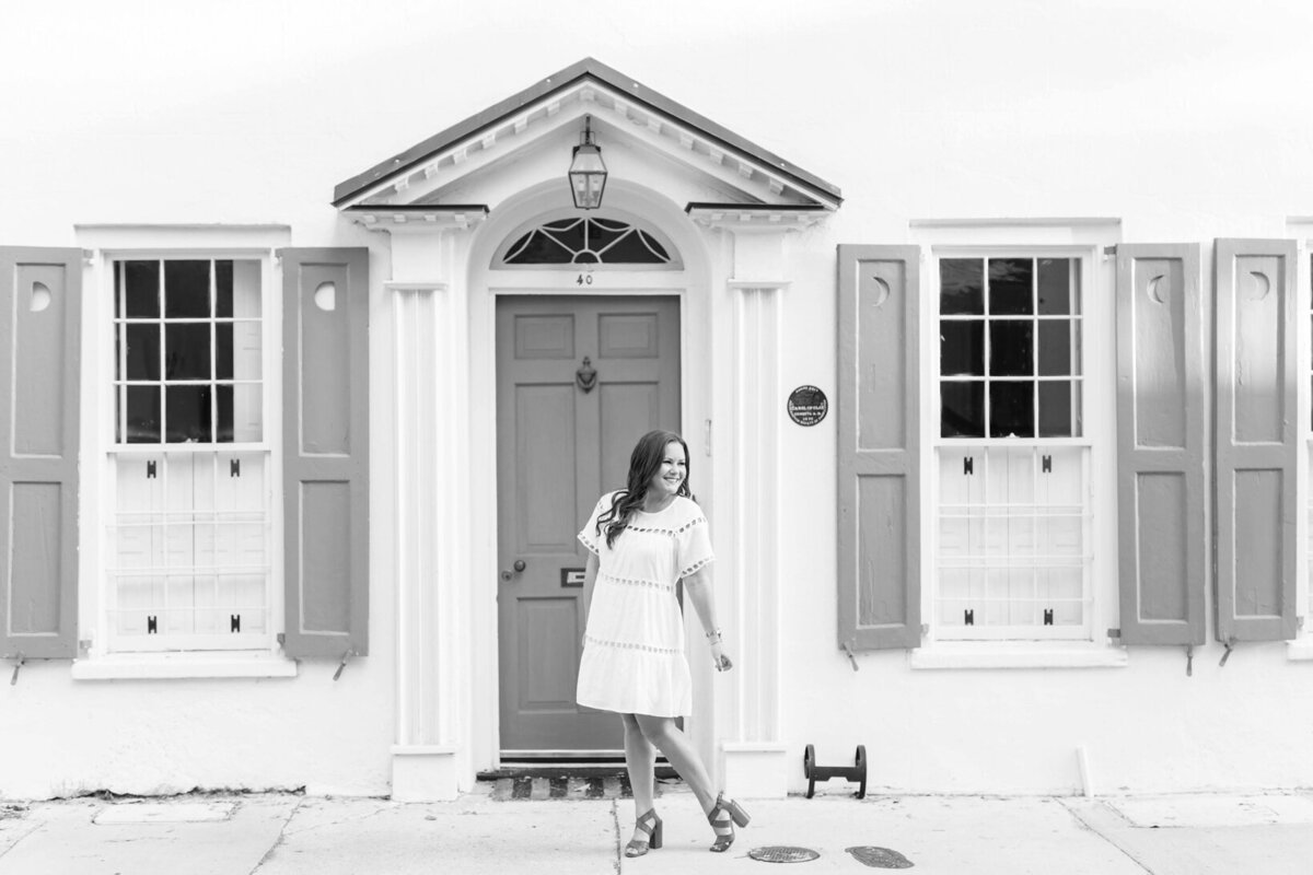 Katie standing in front of a charming house