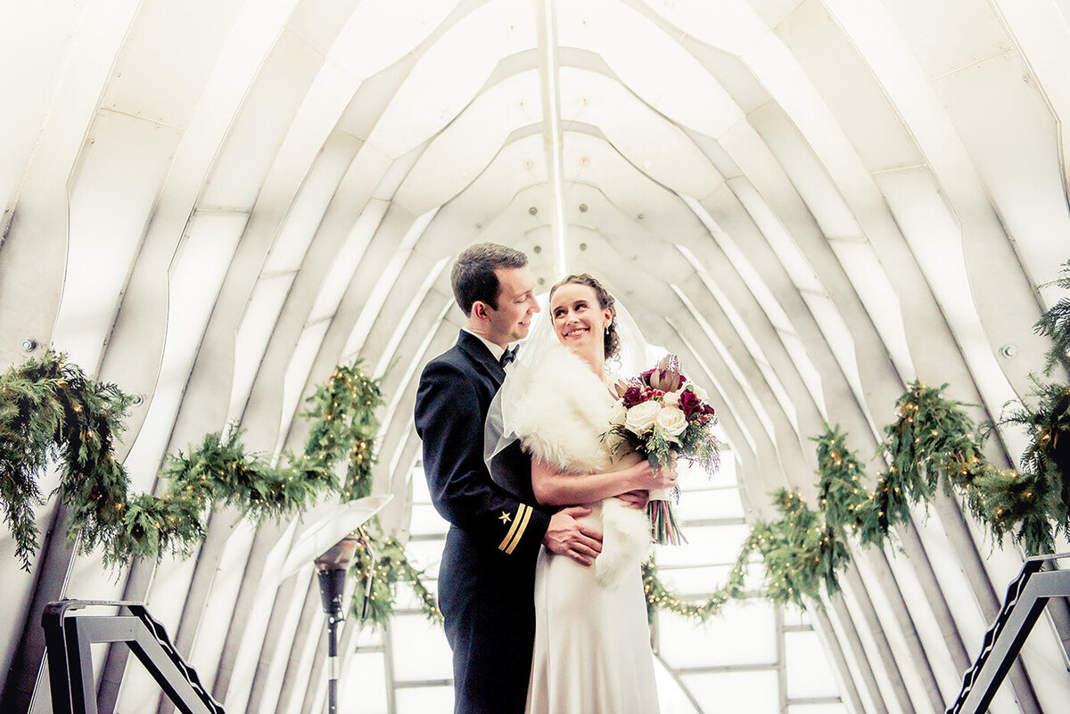 bride and groom posing in tunnel