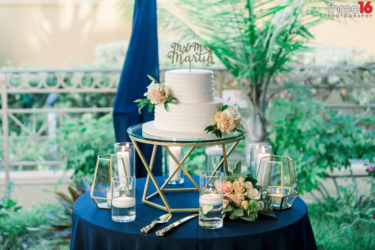 Two-tiered wedding cake ready to be cut