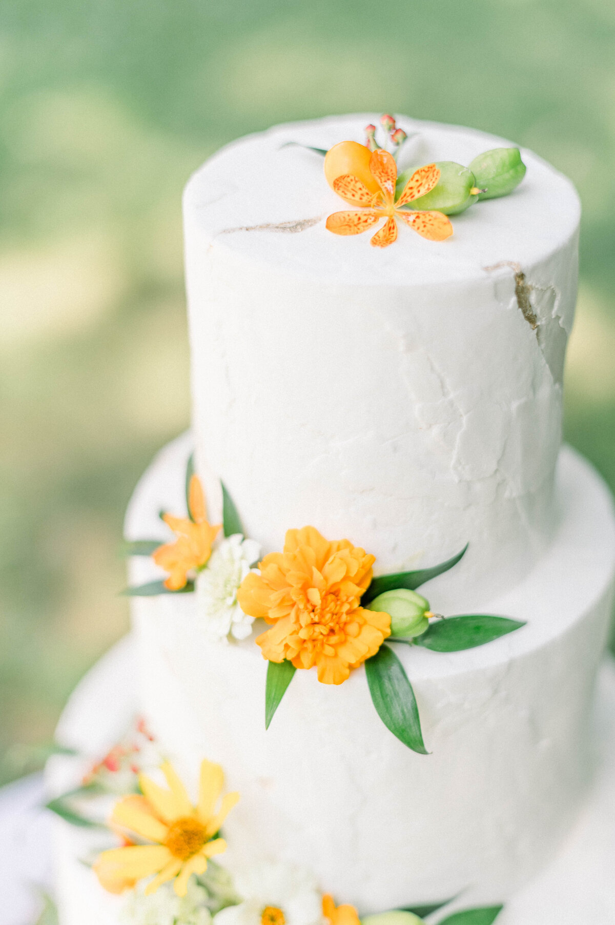 Summer wildflowers used as decor for a wedding cake