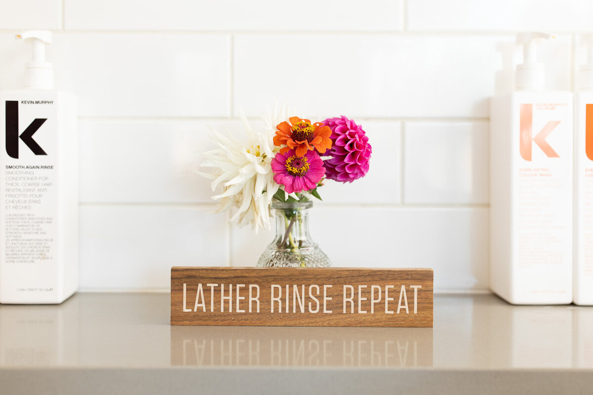 Rinse, lather, repeat sign in salon.