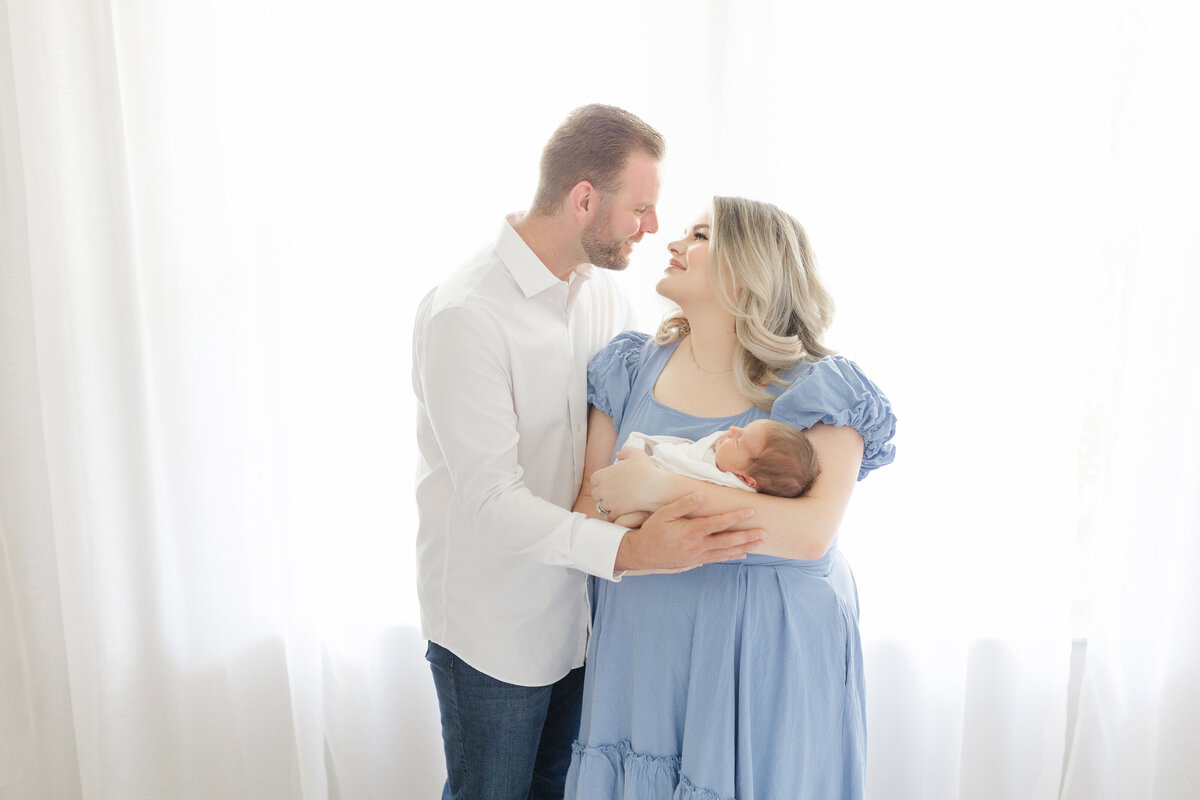 Luxury Tampa family portrait in airy natural light studio with neutral palette