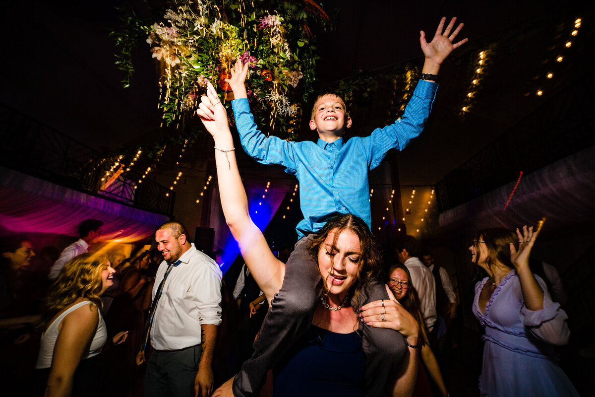 One of the top wedding photos of 2020. Taken by Adore Wedding Photography- Toledo, Ohio Wedding Photographers. This photo is of wedding guest dancing and having a great time during the wedding reception