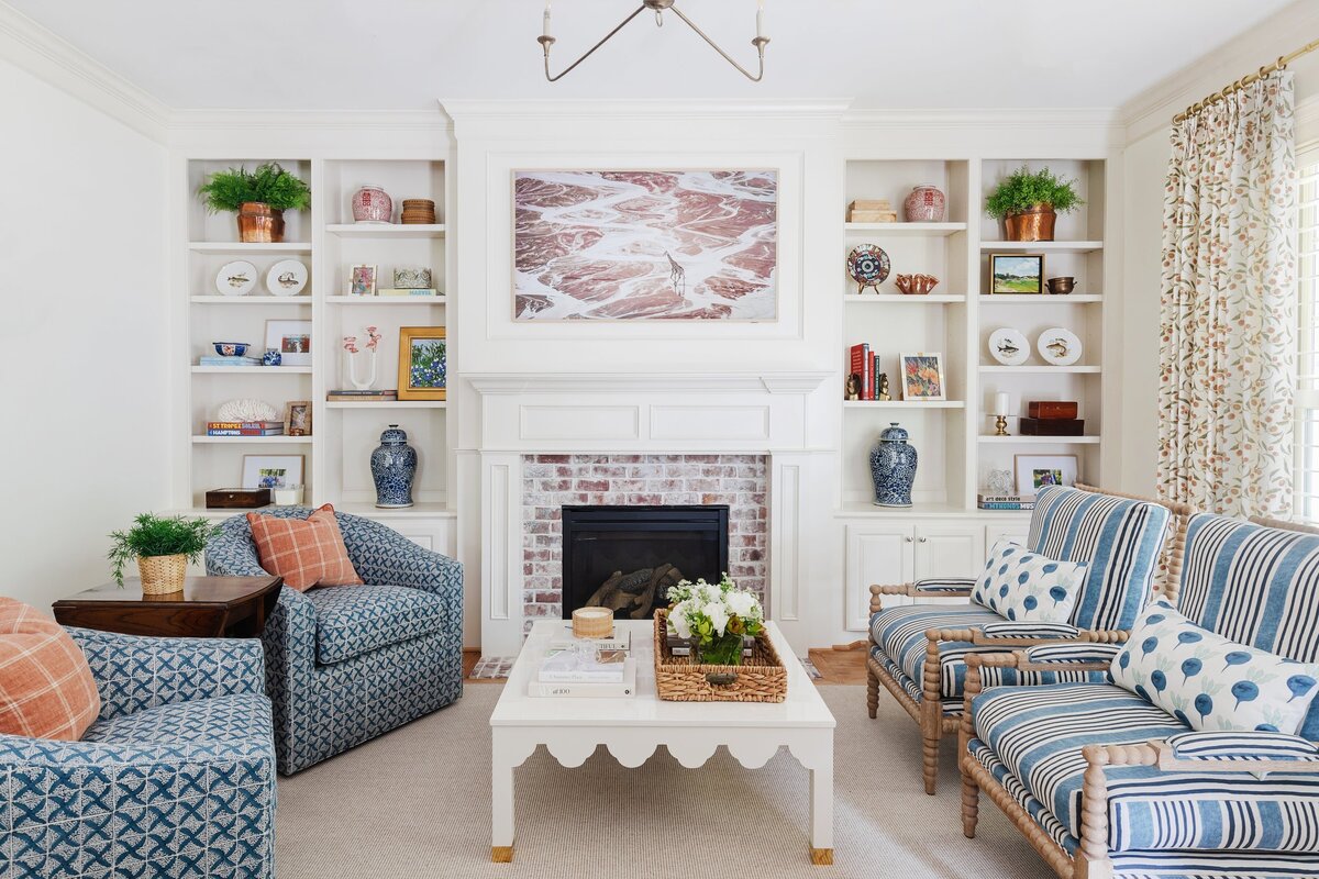 oyster creek studios oak forest remodel patterned arcmhairs around a white coffee table in living room with white shelves