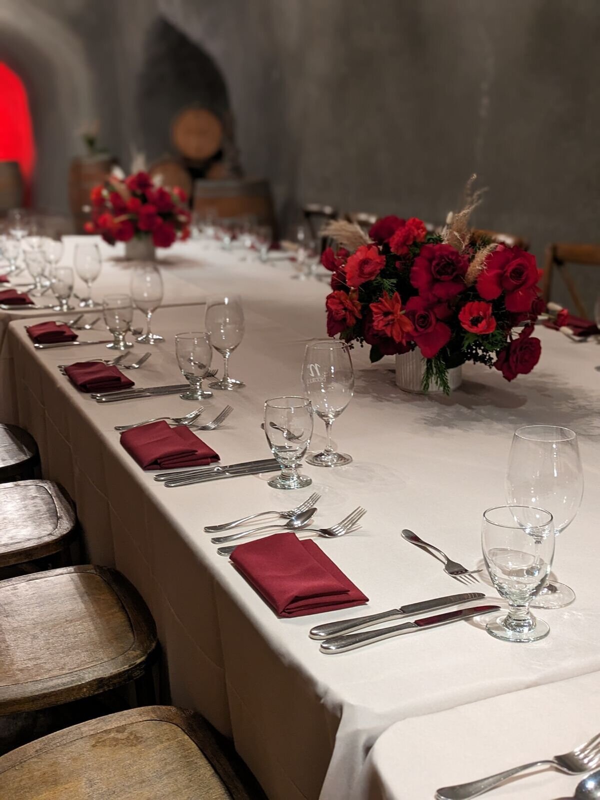 kings tables, oblong arrangements, red flowers, pampas grass, winery, holiday party 