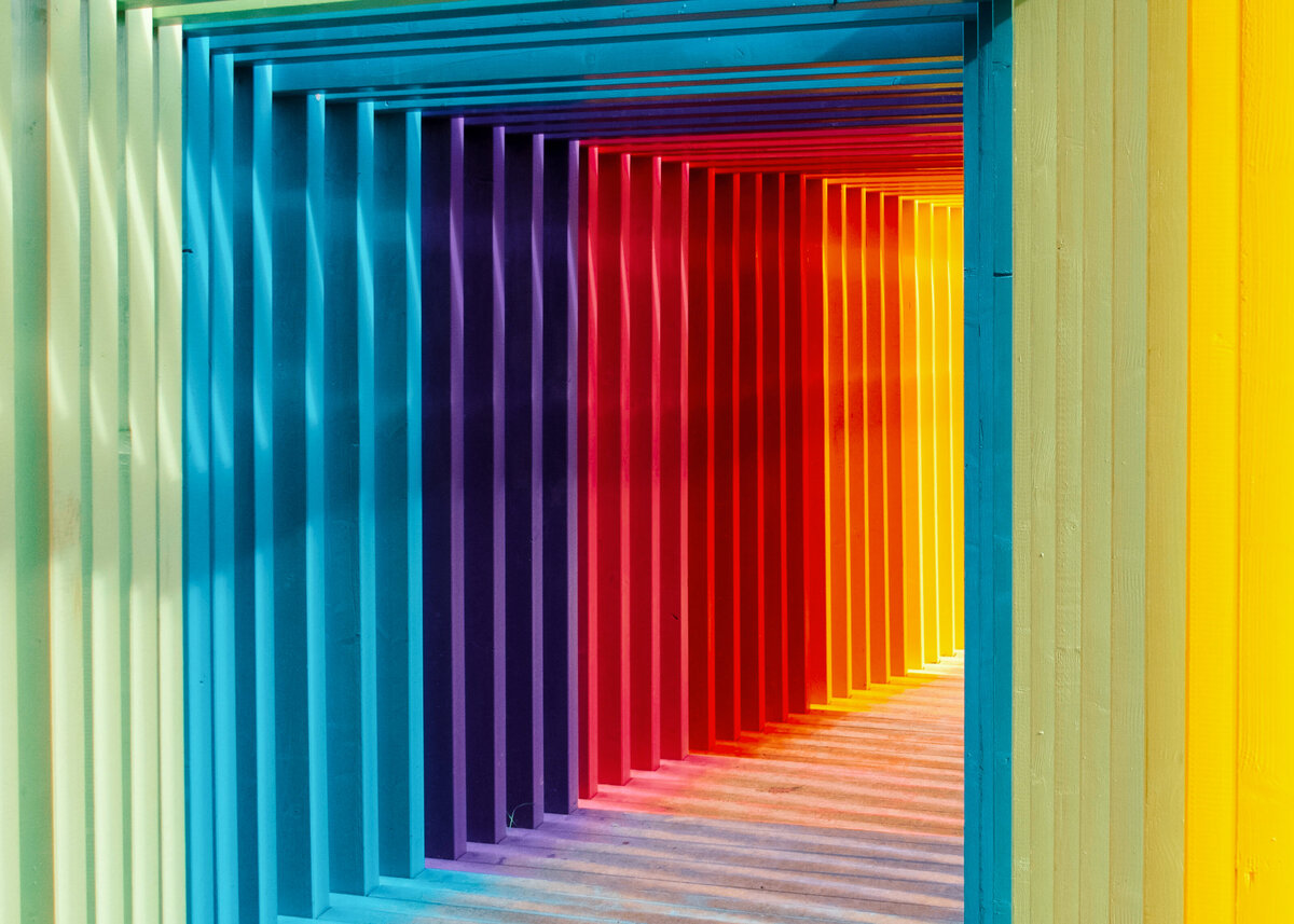 A multicoloured immersive art installation tunnel for a brand event