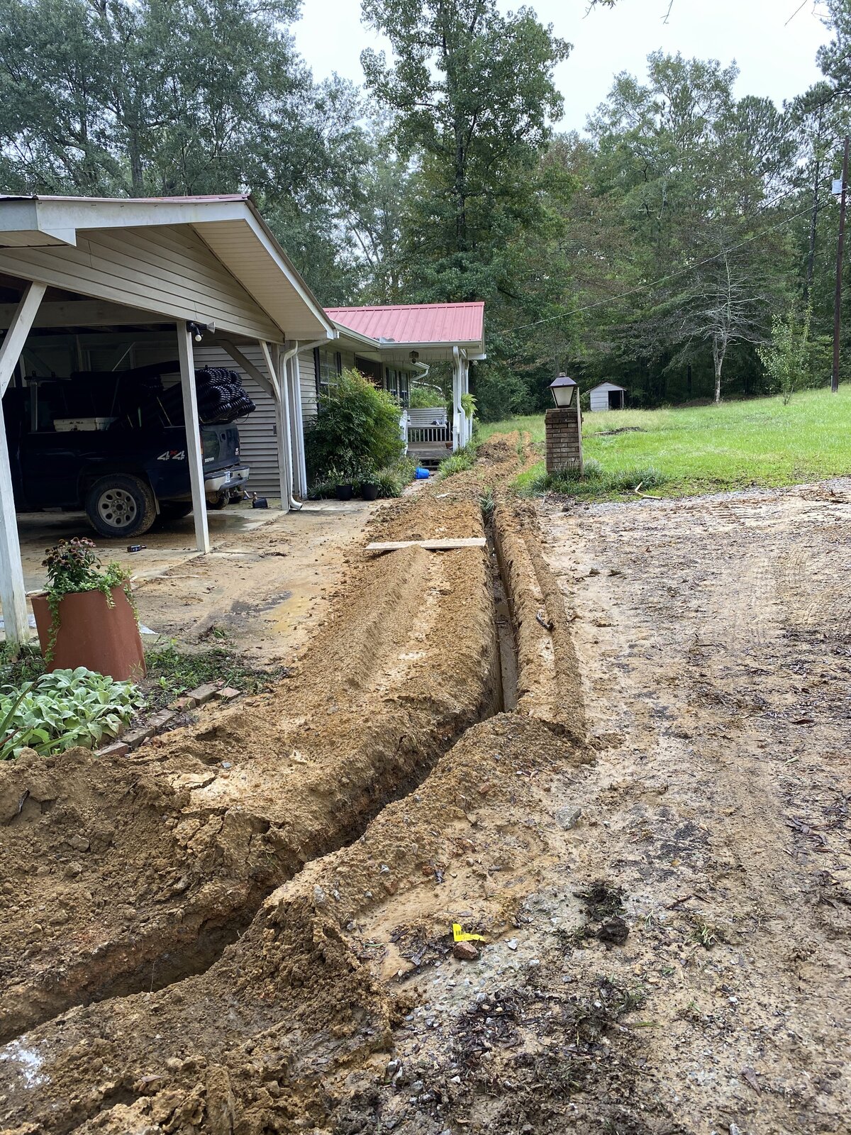 dirt-trench-in-front-of-house-carport