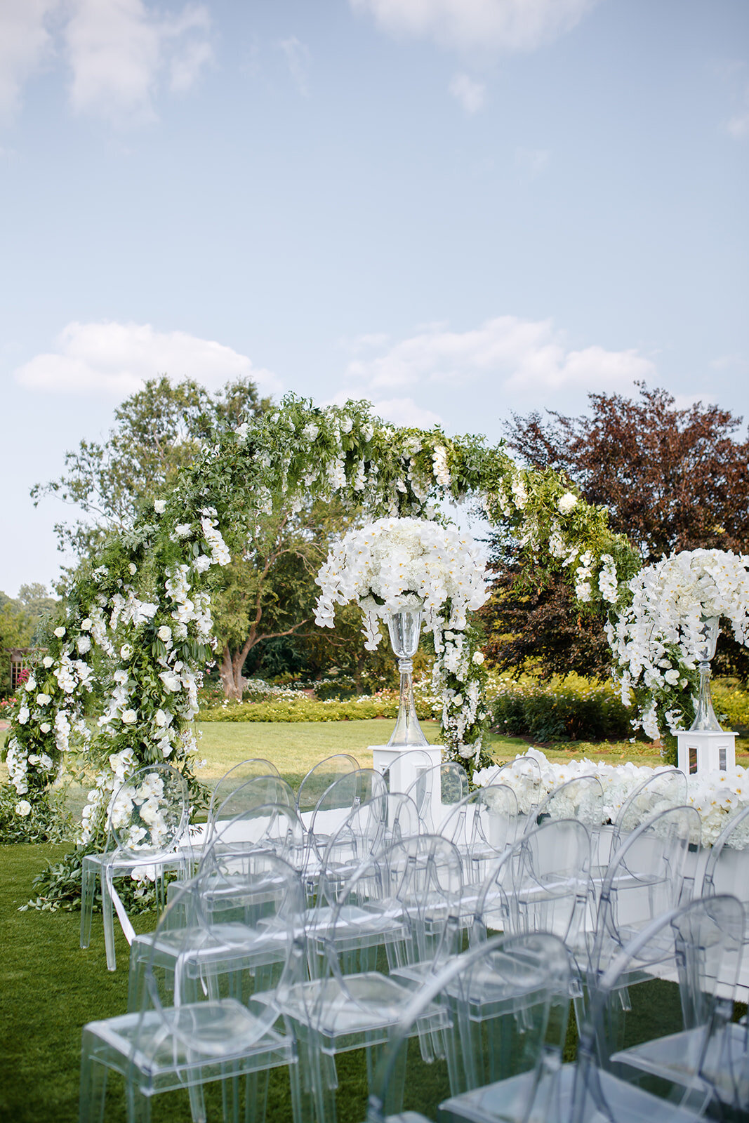 Elegant water fountain adorned with white floral arrangements.