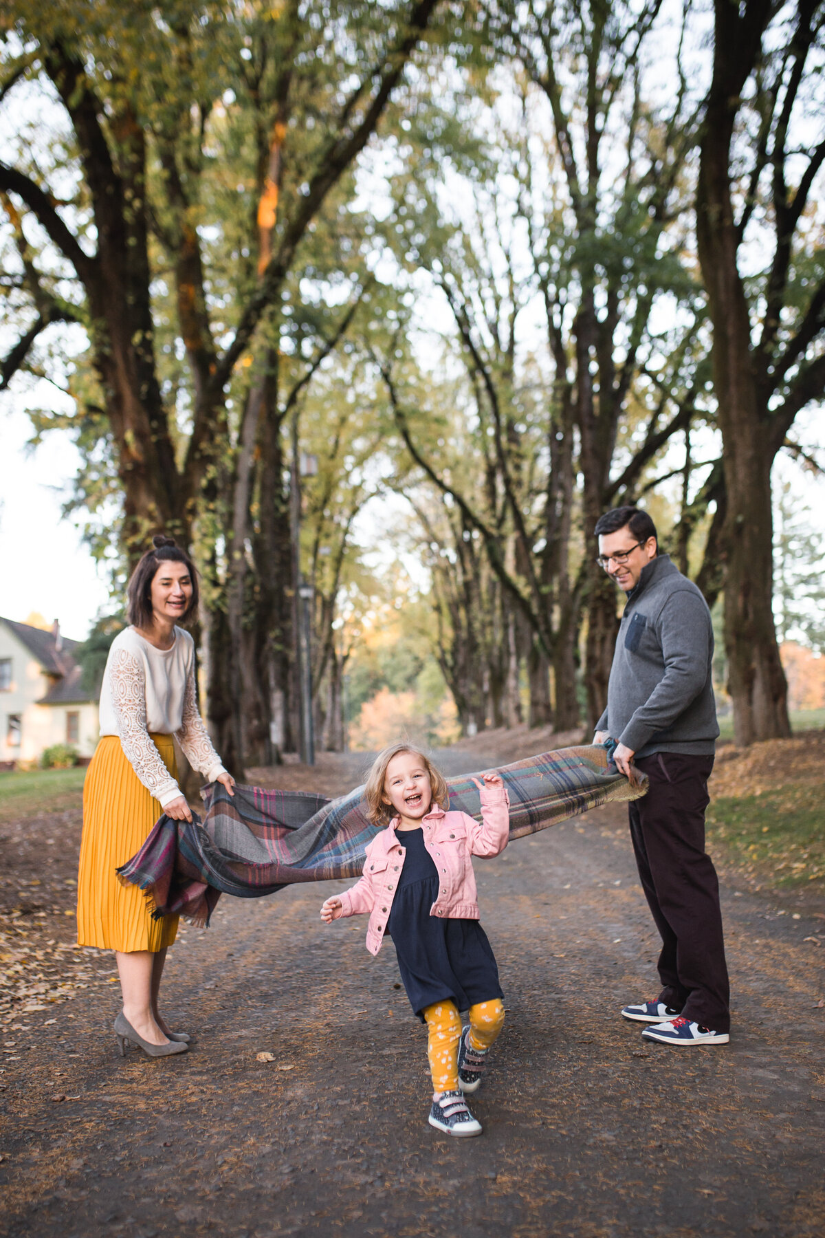 Family playing with daughter in outdoor Portland area photography session