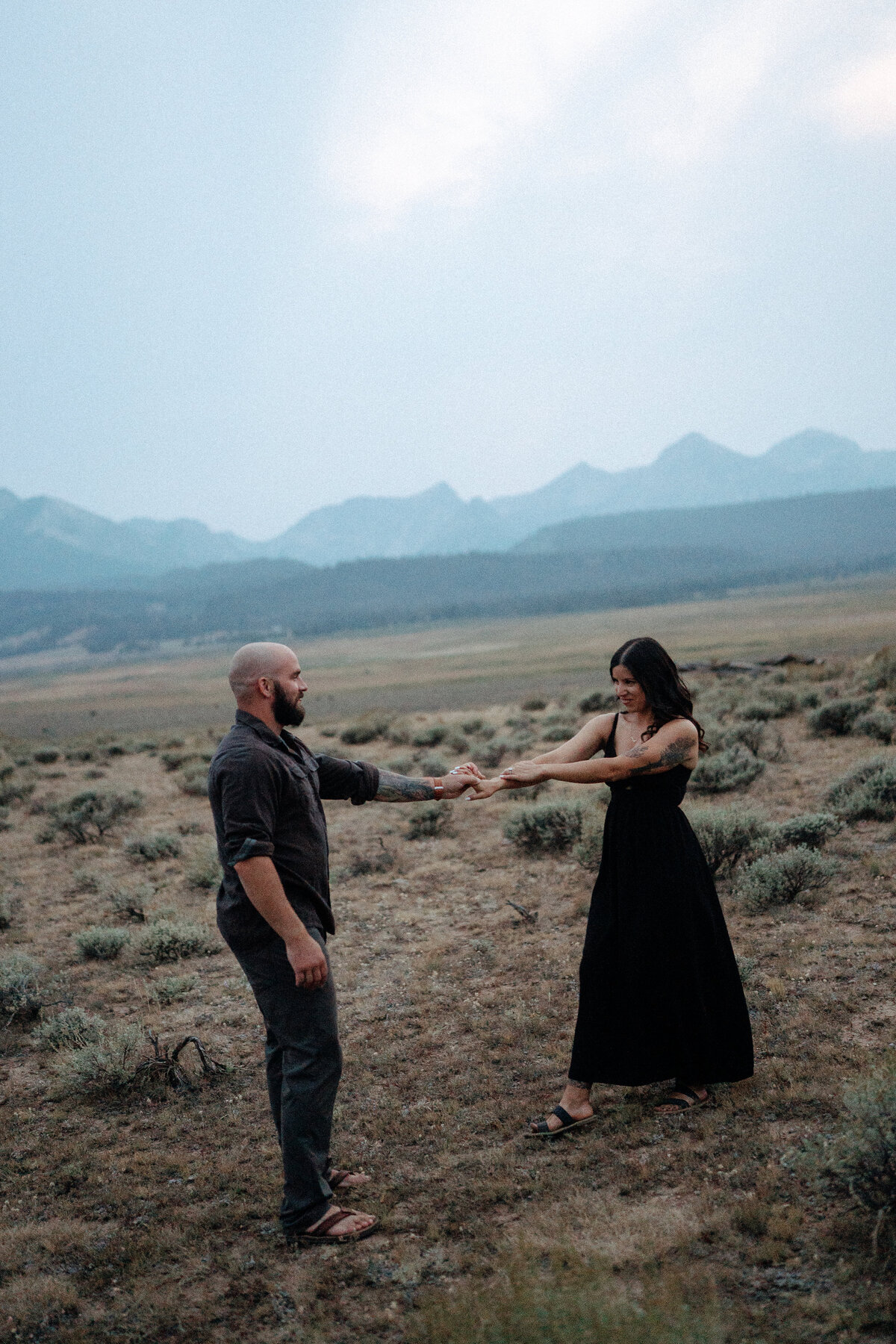 Couple during golden hour engagement shoot in Stanley, Idaho wedding/elopement - photographed by The Storytellers