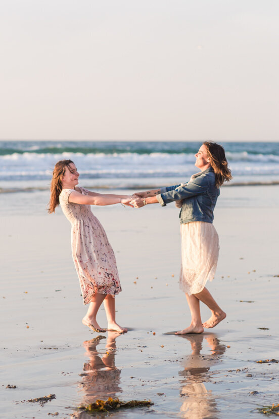 mother-and-daughter-twirling-on-la-jolla-beach-san-diego