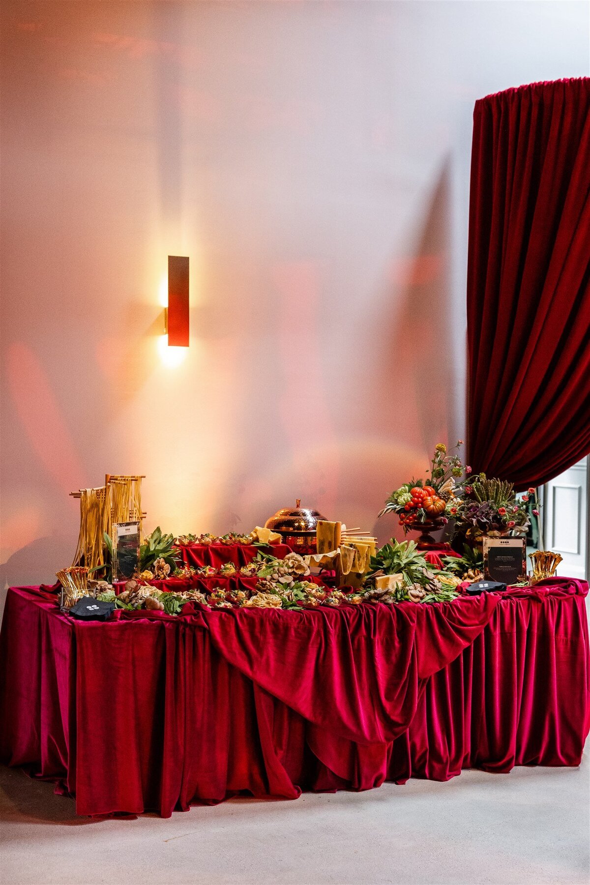 Venue space styled as a bread and butter station, featuring a rustic display of assorted artisan breads, flavored butters, and decorative serving boards arranged on a linen-covered table