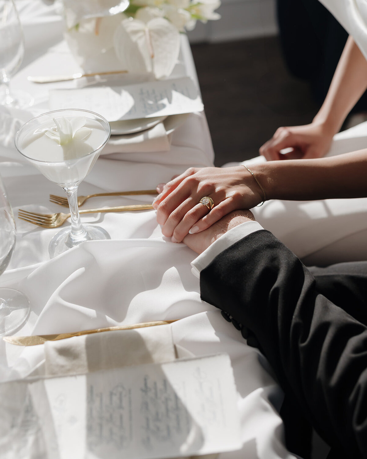 bride and groom hold hands