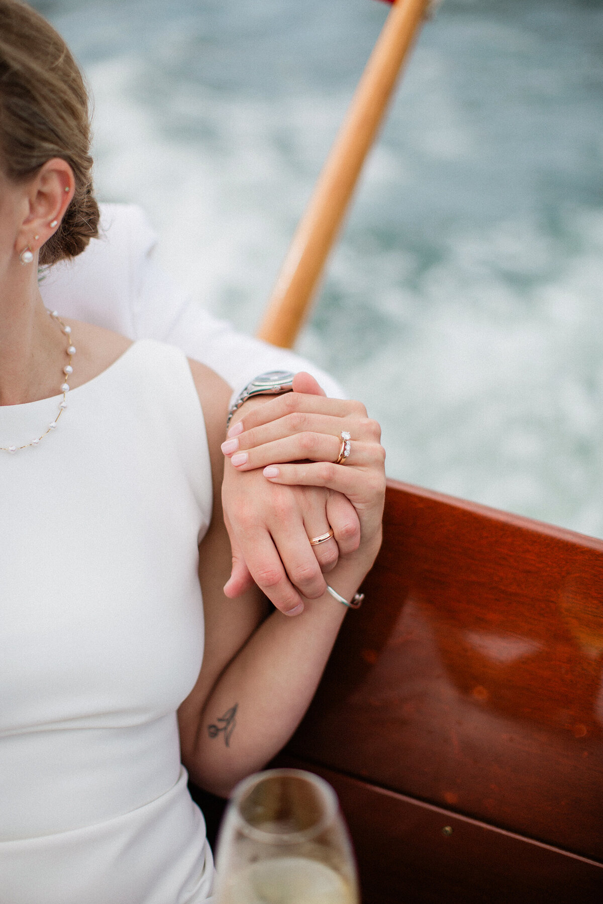 couple holding hands on boat during wedding
