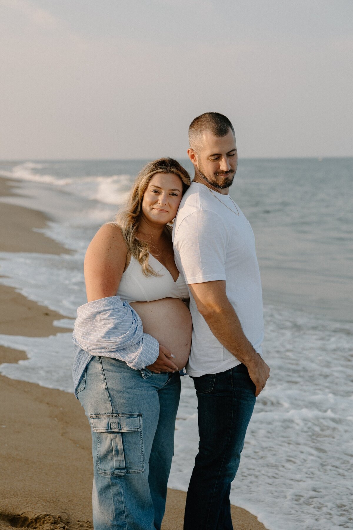pregnant woman and man on beach