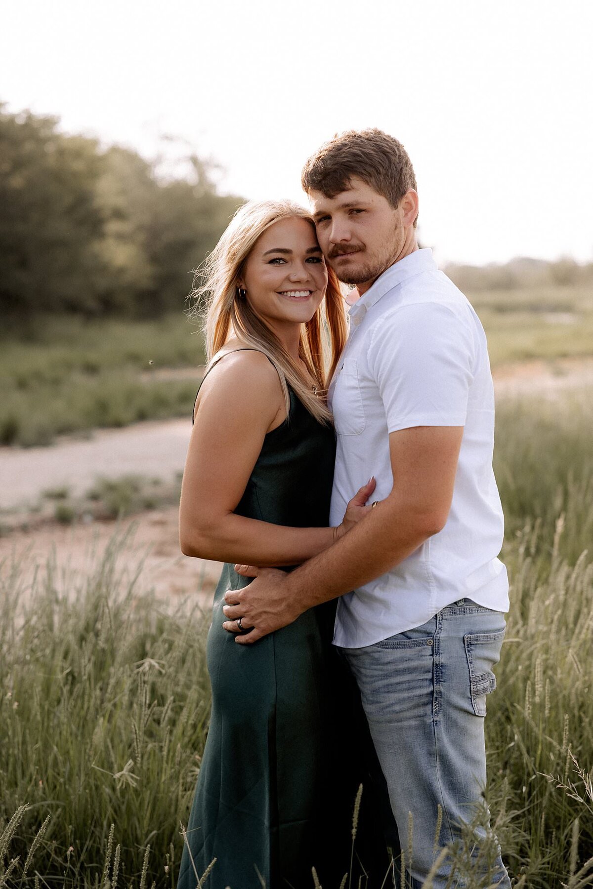 Couple embracing looking at the camera.