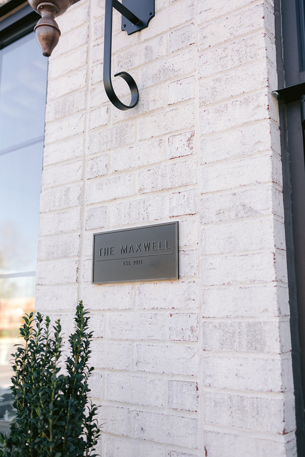 Maxwell's front door sign in bronze
