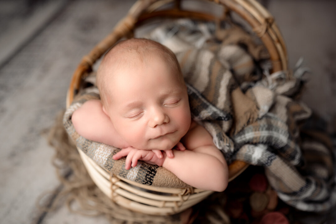 Grand Rapids Newborn Photography Baby Laying on arms by For the Love of Photography